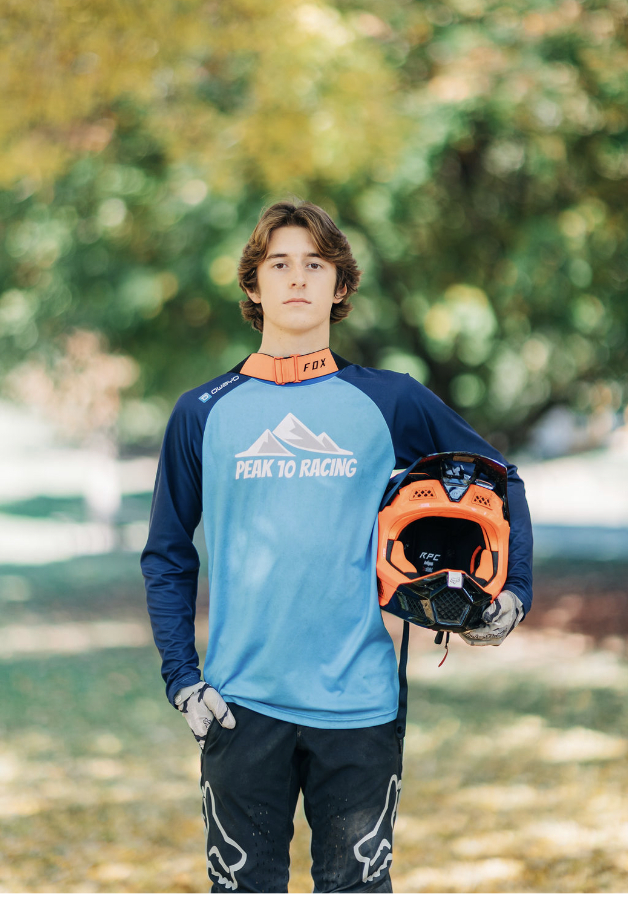 Blake Fisher in Peak 10 Racing kit holding a full-face helmet